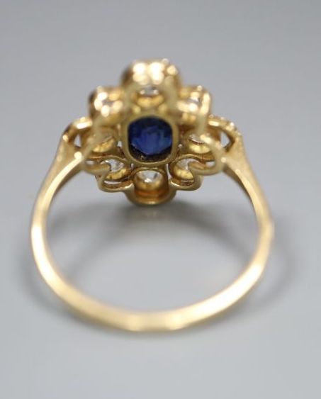 An early to mid 20th century 18ct, sapphire and diamond set quatrefoil cluster ring, size L, gross 3.2 grams.